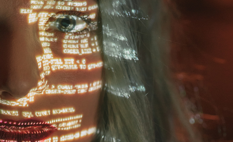 woman with code reflected on her face