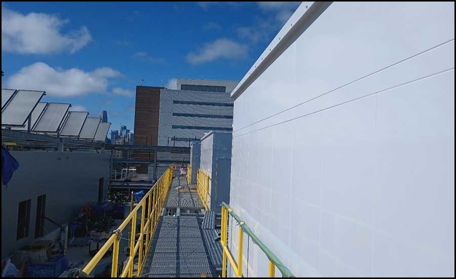 Solar Thermal Drain-back Panels for HHW and DHW on top of the penthouse mechanical and electrical rooms - left. Triple deck AHU’s with second deck maintenance walkways on the right.